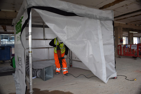 Main image - DUSTEX® Dust Trap being used by a site operative to contain dust during ground breaking site activities 1