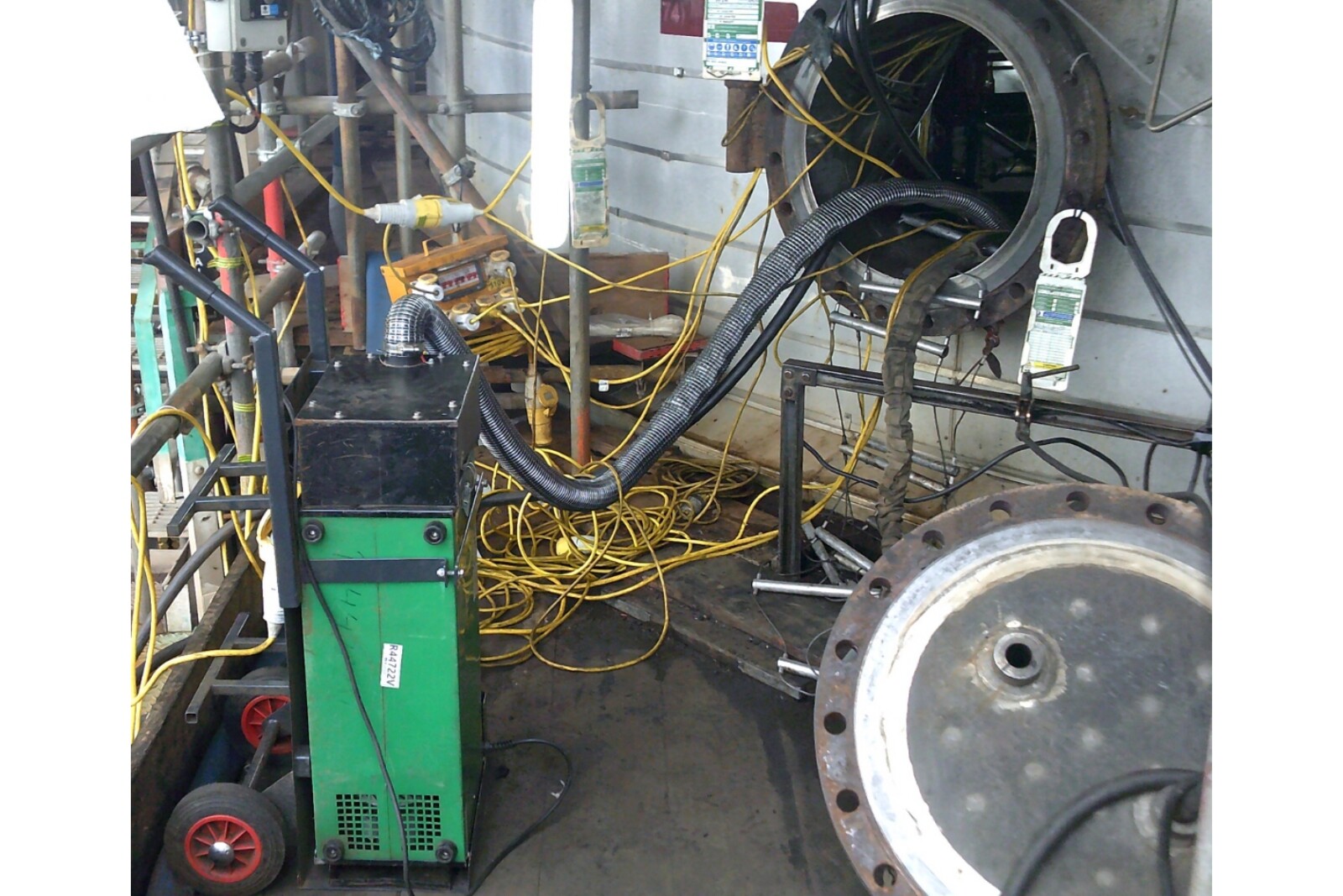 RAVEX Portable Welding Fume Filtration Unit with lots of wires and pipework leading into a oil refinery porthole