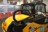 Ravex Diesel Filter Kit M30 secured to the side of a loader with flexible hosing coming from the exhaust to the scrubber