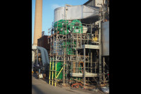 4 VENTEX Centrifugal Fan 800S units on the bottom, middle and top level of a scaffolding structure next to an industrial plant_