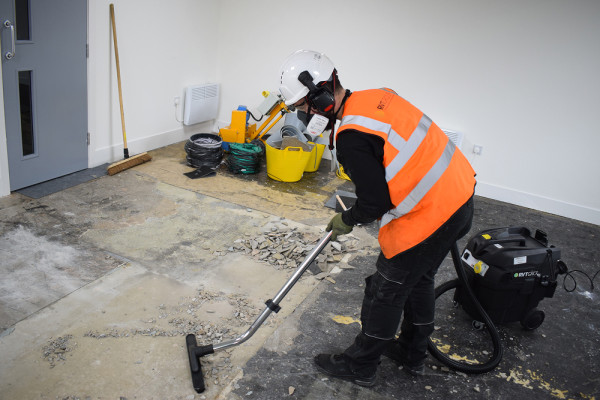 Main header image - RVT Group's DUSTEX® B4 M Class Vacuum Cleaner collecting dust and debris using a floor bar