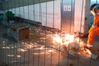 VENTEX Centrifugal Fan 300M making up part of a fume extraction system whilst a nearby rail worker performs steel cutting with hot sparks coming from the works