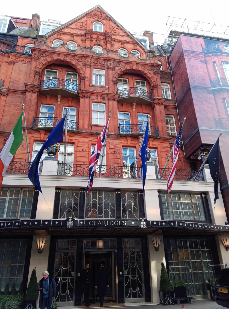 Front elevation of Claridges hotel in London with flags above the entrance