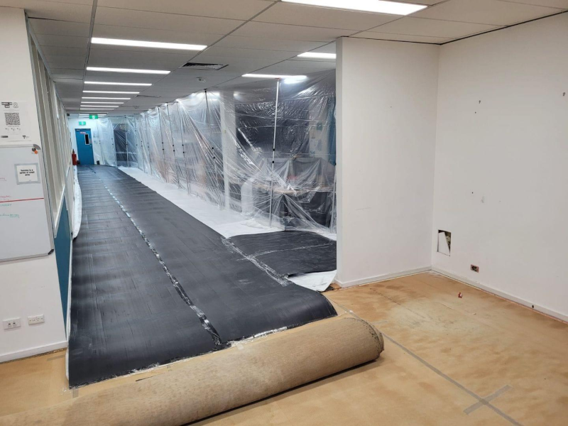 Plastic sheeting dust screen and floor protection in an office corridor during fit out