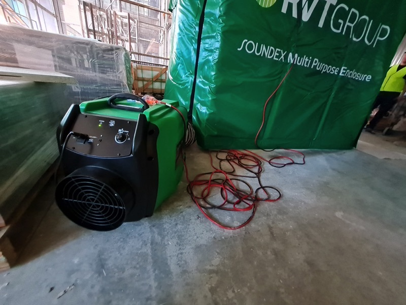 Portable heater beside an RVT SOUNDEX acoustic enclosure on site