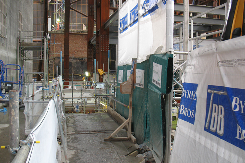 Scaffolded work area with RVT acoustic screening on a construction site