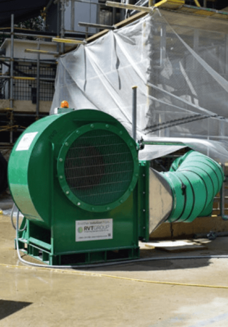 Green RVT centrifugal fan and ducting outside a screened work area