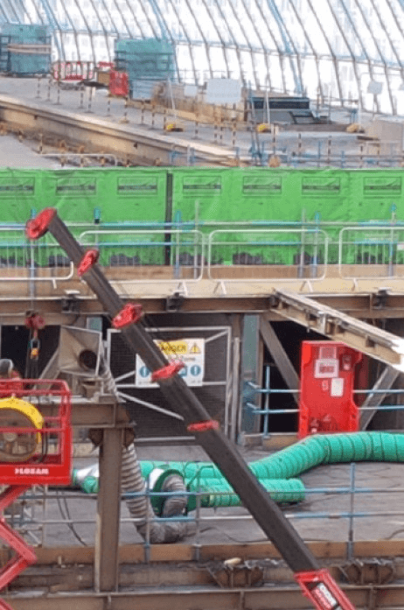 Green acoustic screening and ventilation ducting on a station roof works site