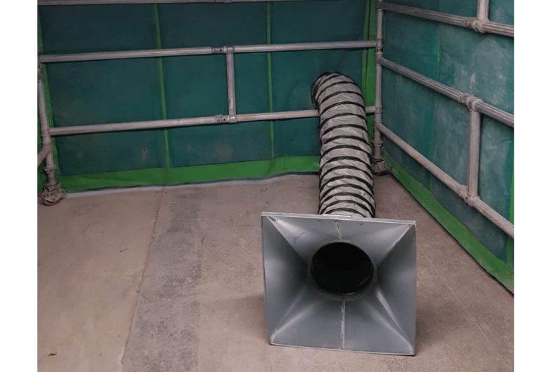 Ventilation ducting and extraction hood inside a screened work area