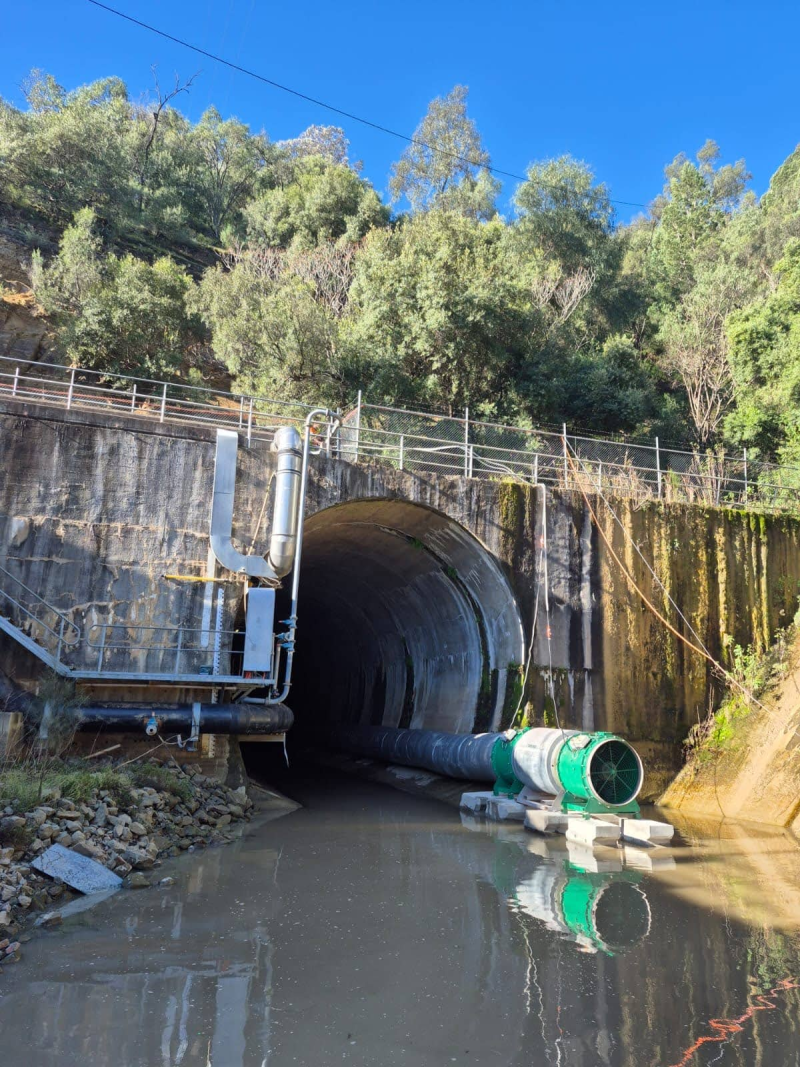 Green RVT ventilation fan and ducting at the mouth of a railway tunnel