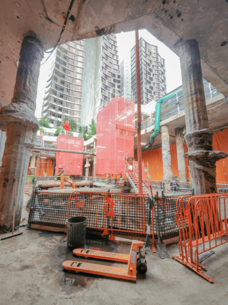 Basement strip out below apartment towers with hoardings and scaffolding