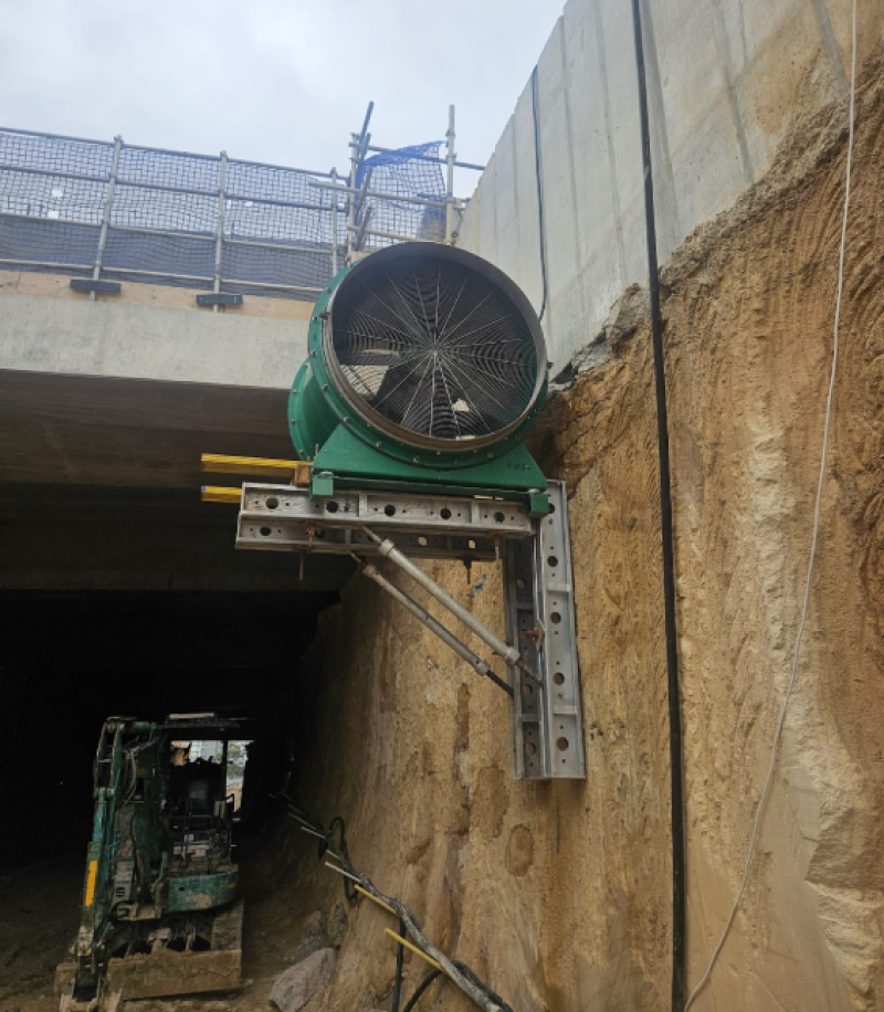 Green RVT axial fan bracket mounted on the wall of an excavation
