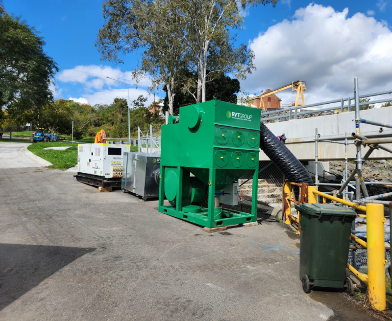 Green RVT dust filtration unit beside generators on a bridge works site