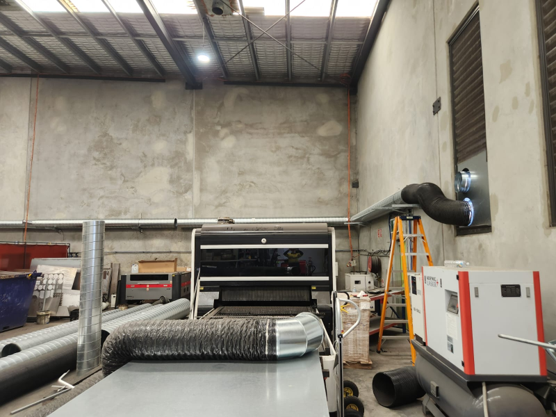 Ducting and a mobile air handling unit installed inside an industrial workshop