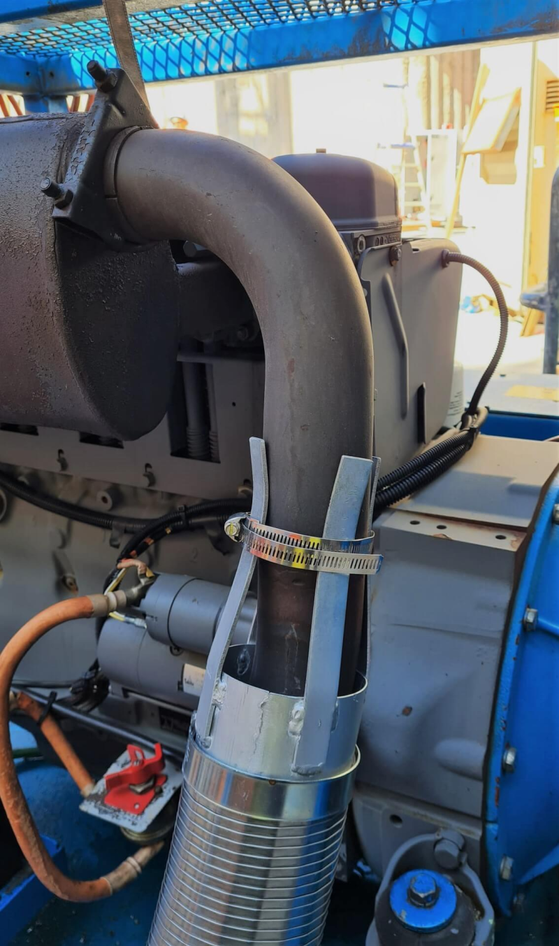 Diesel exhaust filter clamped to a machine exhaust pipe