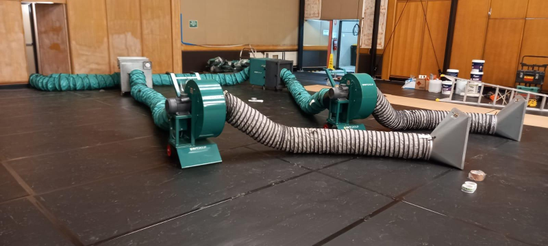Two RVT fume extraction fans with ducting and hoods set up in a hall