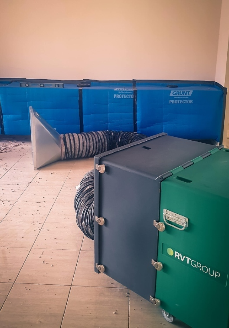 RVT filtration unit with extraction hood in a room being stripped out