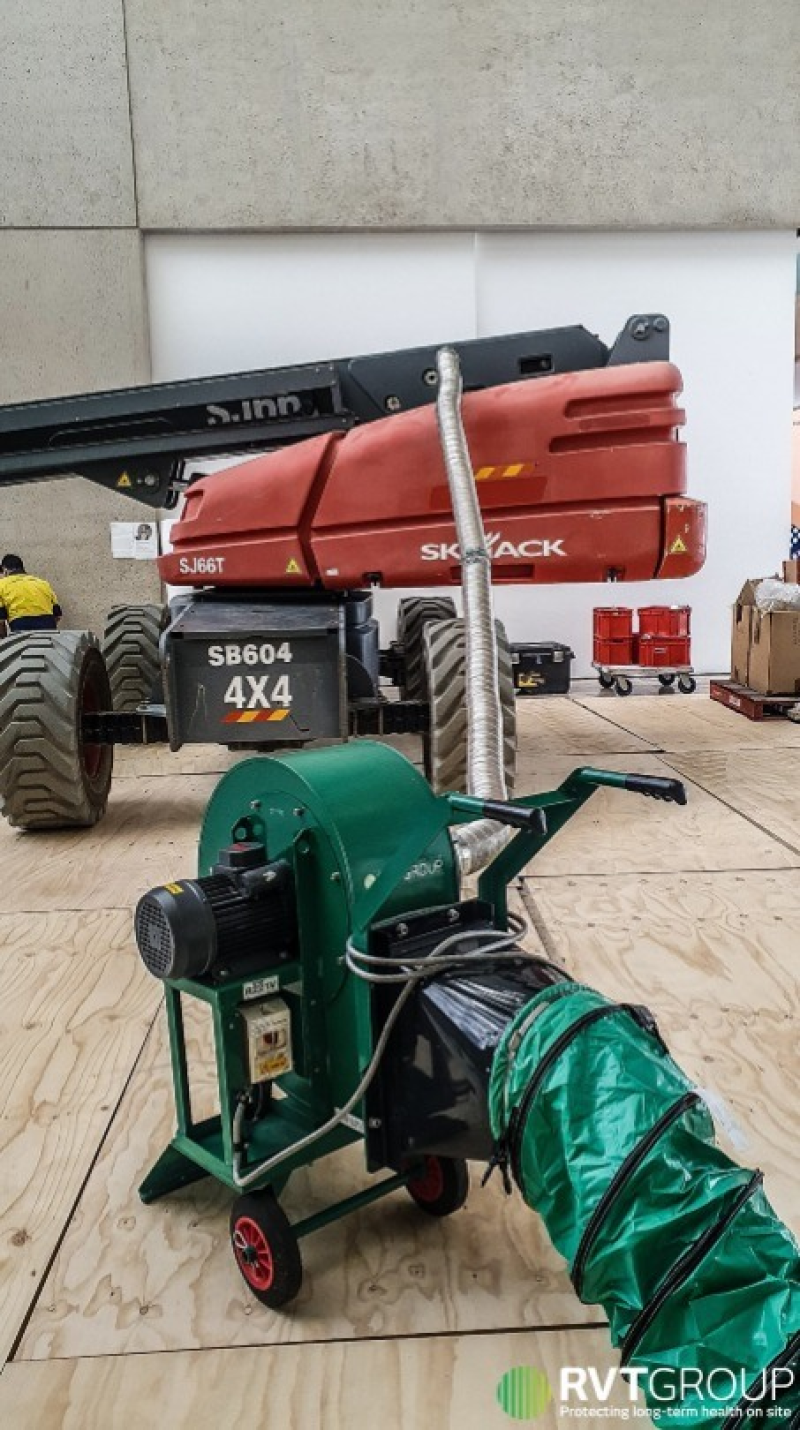 RVT extraction fan and ducting beside a boom lift inside a gallery