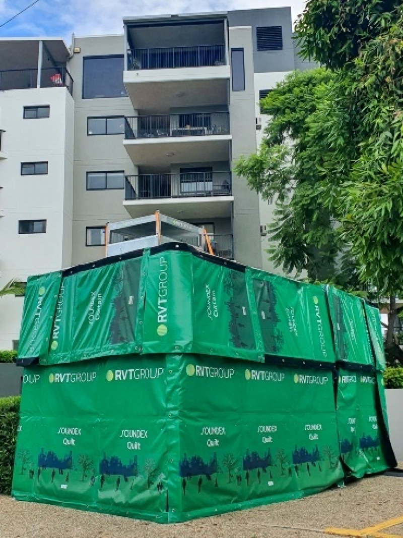 RVT SOUNDEX acoustic curtains and quilts around a generator beside apartments